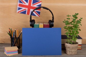 Fototapete - blue blank paper, flag of the Great Britain, headphones, books and chancellery on the table