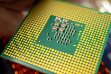 Green electronic chip CPU closeup. Concept of high technology and repair microchip