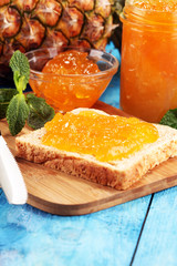 Wall Mural - Toast bread with homemade pineapple jam or marmalade on table served with butter for breakfast or brunch