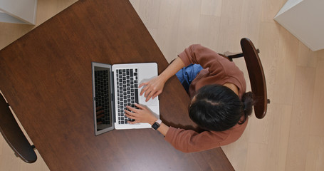 Wall Mural - Woman use of computer from top