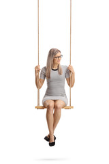 Canvas Print - Young cheerful woman sitting on a swing