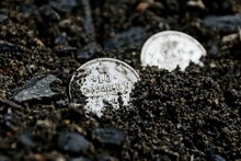 Two White Retro Silver Coins Lying In Black Ground