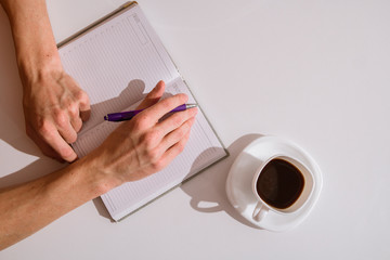 Notepad and coffee on the table