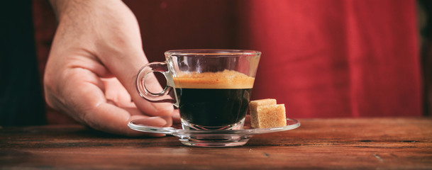 Waiter holding a cup of espresso