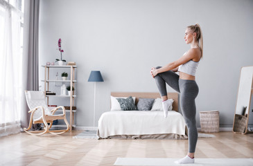 Fit sportswoman exercising and training at home.