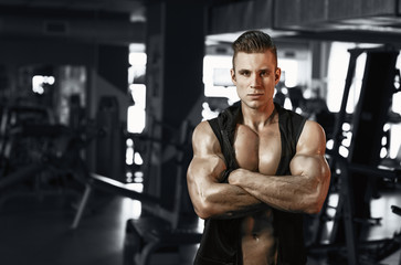  Muscular model sports young man exercising in gym. Portrait of sporty healthy strong muscle. Fitness trainer. Sport workout bodybuilding motivation concept. Sexy torso.