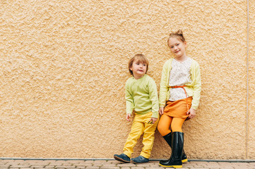 Wall Mural - Outdoor portrait of adorable fashion kids, wearing yellow clothes