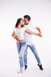 © satura_ - Young couple dancing social latin dance bachata, merengue, salsa. Two elegance pose on white background