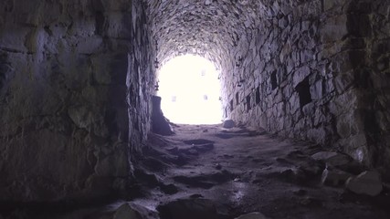 Wall Mural - Static shot, of light at the end of the tunnel, underground, inside the walls of Suomenlinna fortress island, in Helsinki, Finland