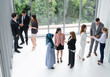 © InfiniteFlow - Many business people gathering in modern office building for business conference in the city. Businessmen and businesswomen communication and human resources concept.