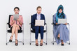 © InfiniteFlow - Business people job applicants sitting and waiting on chairs in office. Job application and recruitment concept.