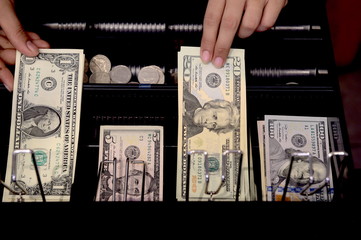 High angle view of cashier searching for change in cash