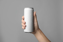 Woman Holding Aluminum Can With Beverage On Grey Background, Closeup. Space For Design