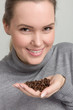 © StudioLaMagica - young woman with coffee beans in her hand