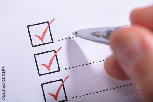 Cuadros en Lienzo Person's Hand Marking On Checklist