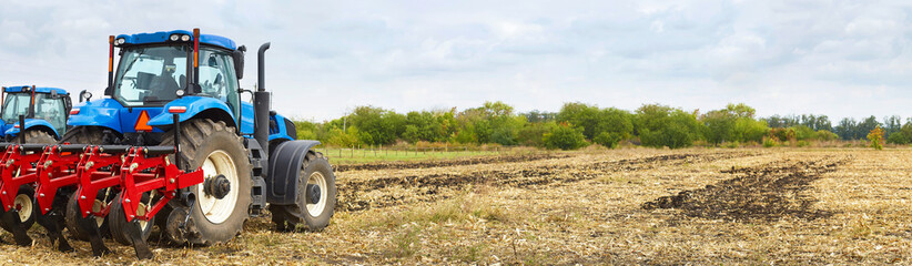 Poster - Several powerful tractors work in the field.