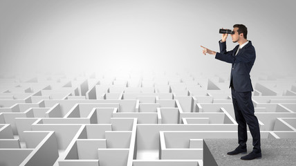 Wall Mural - businessman standing on maze and looking forward to the future concept
