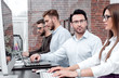 © ASDF - professional business team working on a PC in a modern office