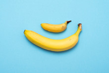 Small Banana Compare Size With Banana On Blue Background. Size Penis Concept