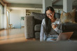 © Jacob Lund - Woman sitting on floor laptop and coffee
