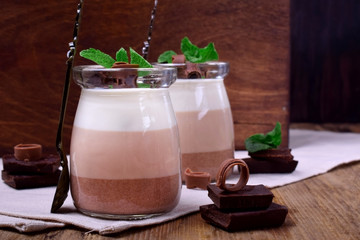 Wall Mural - Three chocolate mousse dessert in a glass jar