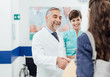 © StockPhotoPro - Doctor welcoming a patient at the clinic