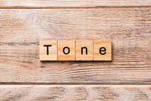 Tone Word Written On Wood Block. Tone Text On Wooden Table For Your Desing, Concept