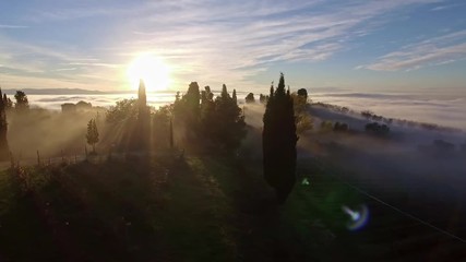 drone flying over foggy mediterranean landscape with beautiful wineries