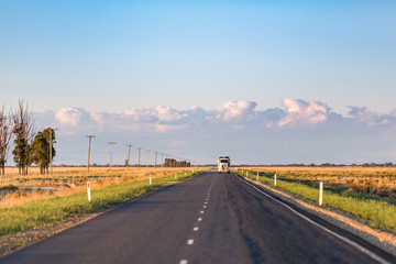 Wall Mural - A truck approaches on a long, straight single lane highway in rural New South Wales.