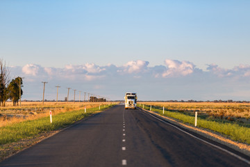 Wall Mural - A truck approaches on a long, straight single lane highway in rural New South Wales.