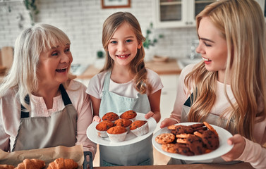 Daughter, mother and grandmother on kitchen