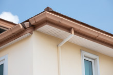 Brown Steel Rain Gutter  With Blue Sky. Concept : Repair Roof In Summer Before Rainy Season.