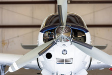 Small White And Blue  Plane In Hangar, Small Cockpit, Private, Straight On