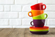 Tea, coffee cups stacked. Neutral background. Space for text.