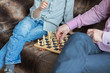 Father and son are playing chess while spending time together