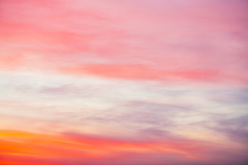 Wall Mural - Sunset sky with pink orange light clouds. Colorful smooth blue sky gradient. Natural background of sunrise. Amazing heaven at morning. Slightly cloudy evening atmosphere. Wonderful weather on dawn.