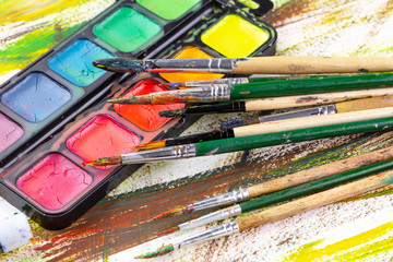 Paint brushes and paints for drawing.