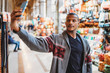 © loreanto - Young man takes a selfie in a market in Florence, Italy