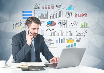 Wall Mural - Man with laptop at table, graphs and infographics