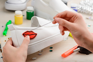 girl sewing a lips patch
