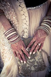 Indian bride mehndi hands with jewelry at a wedding