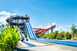 colorful large slider at amusement water park or aquapark in beautiful cloudy and blue sky day