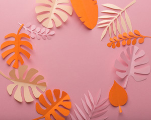 Wall Mural - Pink background with orange and pink leaves of paper in a circle, minimalism