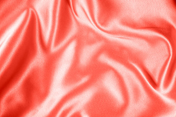 Closeup of rippled coral satin fabric