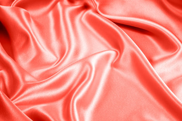 Closeup of rippled coral satin fabric