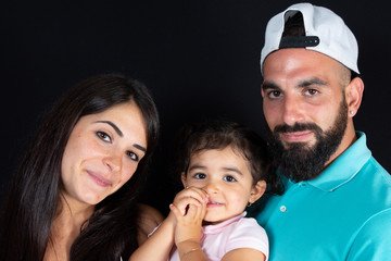 Wall Mural - Family over black Background Three People Happy Parents with Child Father Mother and daughter Isolated