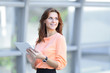 © yurolaitsalbert - confident business woman with digital tablet on blurred office background.