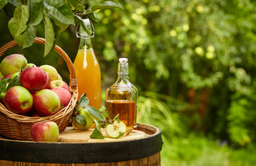 Wall Mural - apples on background orchard standing on a barrel. Apple juice and apple preserves.