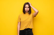 © luismolinero - Young woman over yellow wall with an expression of frustration and not understanding