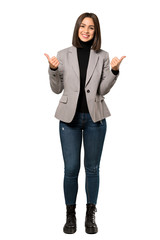 A full-length shot of a Young business woman giving a thumbs up gesture and smiling over isolated white background